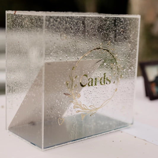 Acrylic card box for weddings, made from clear acrylic and decorated with a gold decal reading “Cards” inside a botanical wreath. This is an example of what could be made with Clear Cut Acrylic’s crystal-clear sheets for stylish event accessories. Ideal for personalized wedding setups, this laser-cut project highlights how Clear Cut Acrylic products work beautifully for custom signage, donation boxes, and tabletop decor with clean, professional edges and lasting clarity. 11