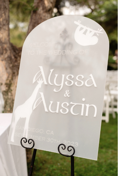 Wedding welcome sign made from frosted and white acrylic sheets, featuring engraved and cutout designs including animals and the couple’s names. This is an example of what could be made with Clear Cut Acrylic for custom wedding decor using laser cutters. Frosted acrylic provides a soft, elegant backdrop, while white acrylic lettering creates strong contrast. Ideal for signage makers crafting personalized ceremony pieces with desktop lasers like Glowforge, xTool, or OMTech. 1